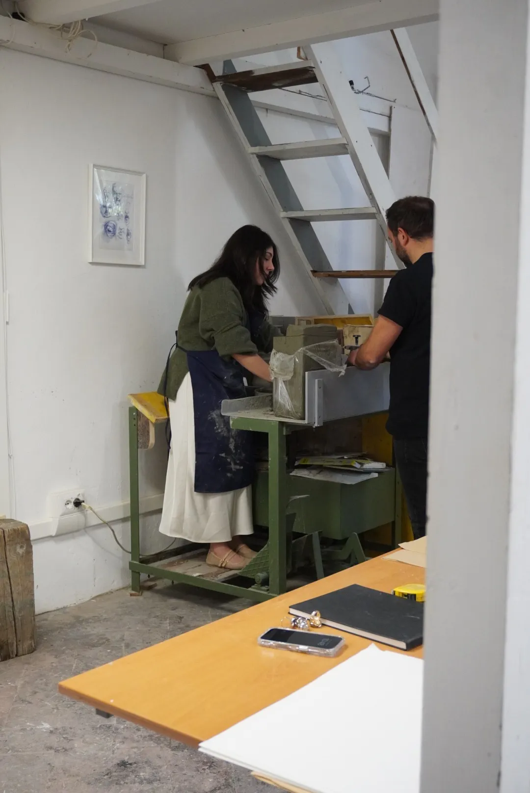 View of the studio with Frida and Enrico Ferrarini working at the bench